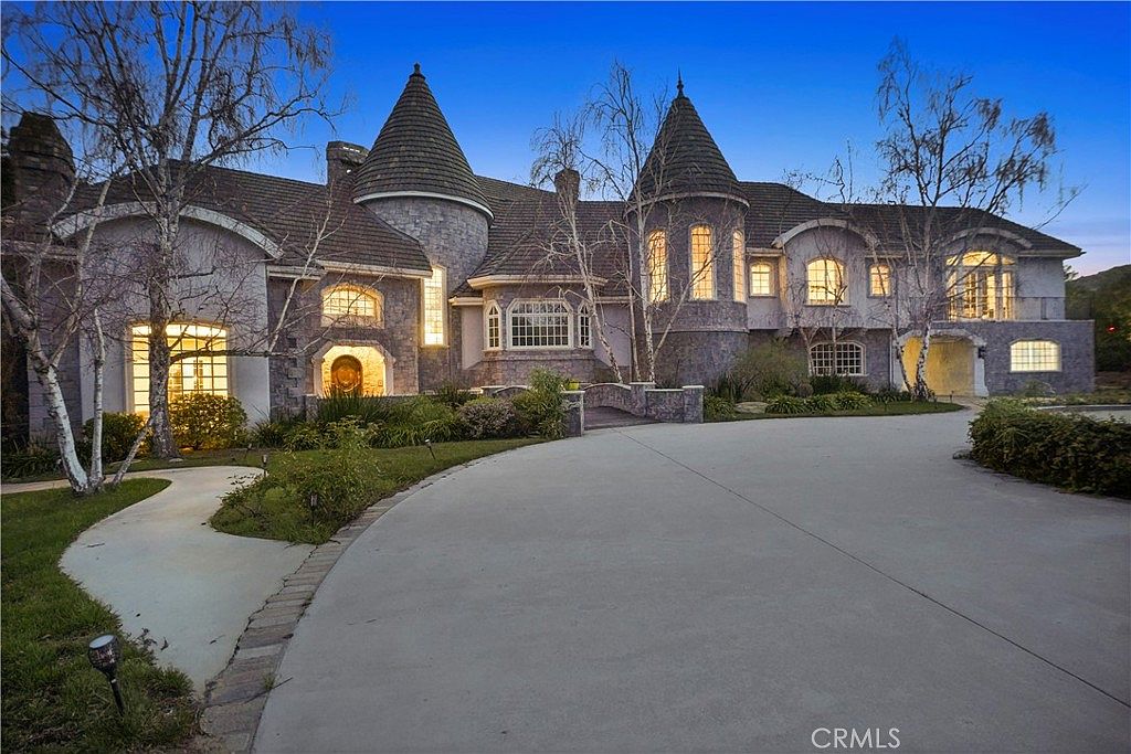 Turrets and stone facade from the driveway at 22510 La Quilla Dr, Chatsworth