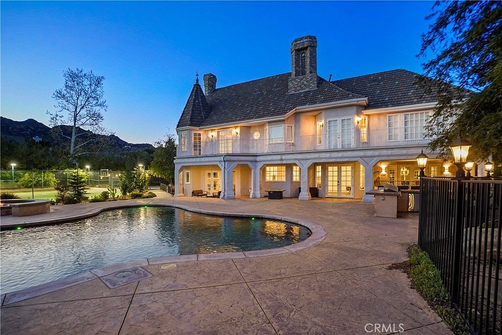 Pool deck and illuminated rear elevation at 22510 La Quilla Dr, Chatsworth