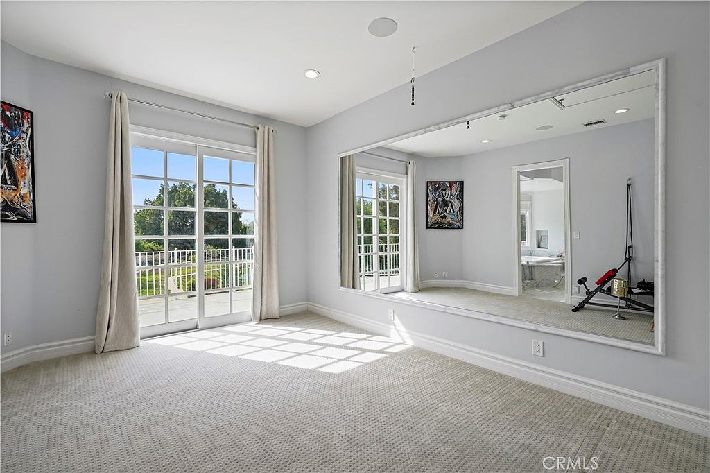 Bonus room with mirrored wall and garden access at 22510 La Quilla Dr, Chatsworth