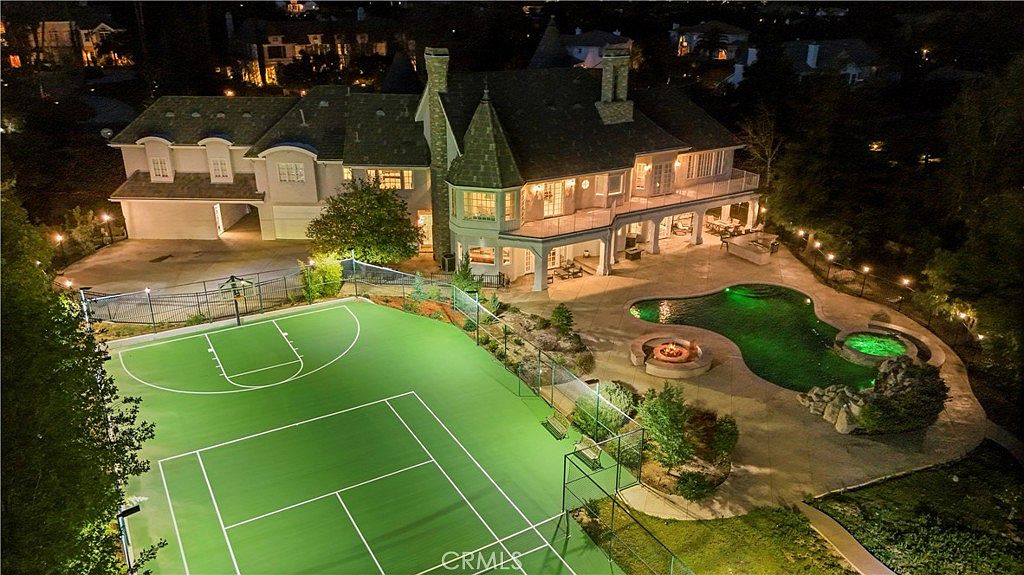 Night aerial over the lit sport court and grounds at 22510 La Quilla Dr, Chatsworth