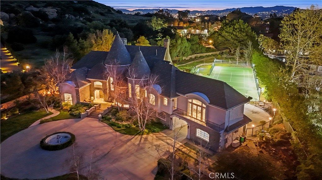 Aerial of the estate and sport court above the valley at 22510 La Quilla Dr, Chatsworth