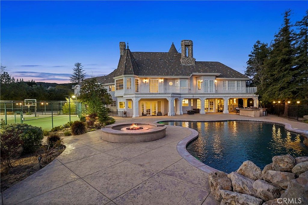 Pool, fire pit and rear loggia at blue hour at 22510 La Quilla Dr, Chatsworth