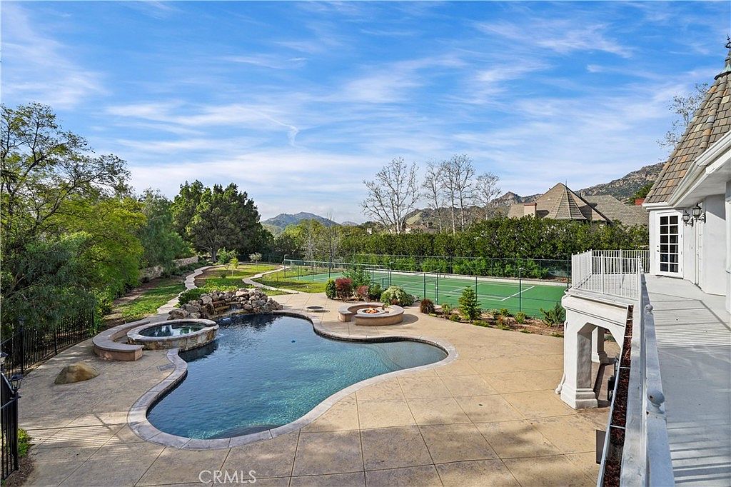 Daytime view over pool, spa and sport court at 22510 La Quilla Dr, Chatsworth