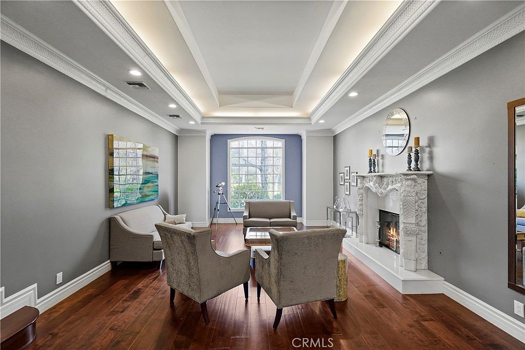 Sitting room with carved marble fireplace at 22510 La Quilla Dr, Chatsworth