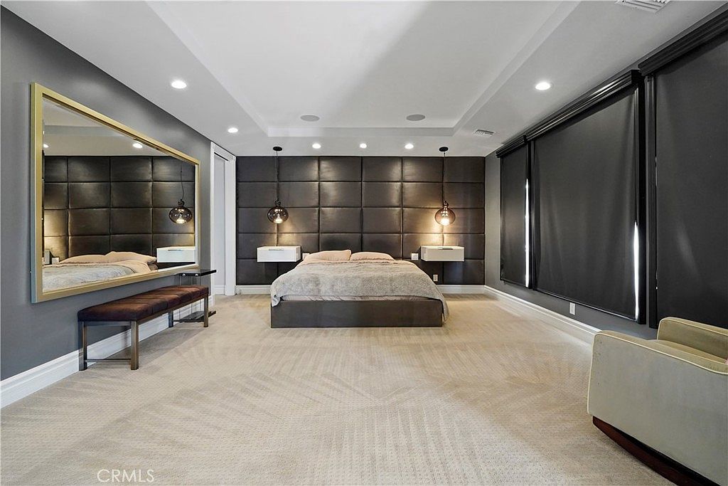 Primary bedroom with upholstered wall and blackout drapery at 22510 La Quilla Dr, Chatsworth