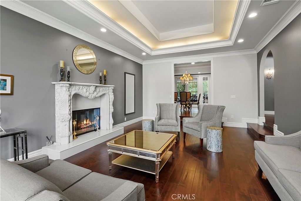 Formal living room beneath a lit tray ceiling at 22510 La Quilla Dr, Chatsworth