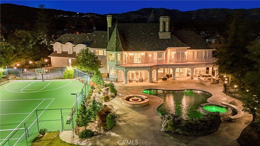 Aerial of the pool, spa and terraces at night at 22510 La Quilla Dr, Chatsworth