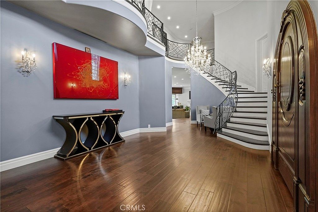 Two-story entry foyer with curved staircase at 22510 La Quilla Dr, Chatsworth
